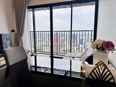 Luxurious living room with stunning city view from high-rise balcony, elegant decor and modern furnishings.
