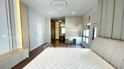 Spacious modern bedroom with elegant design and ample natural light