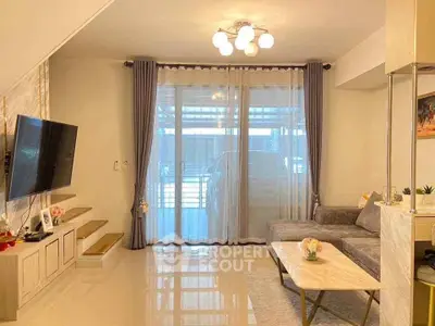 Spacious living room with modern decor and large windows for natural light.
