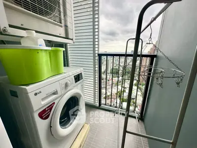 Compact balcony with washing machine and city view, perfect for urban living convenience.