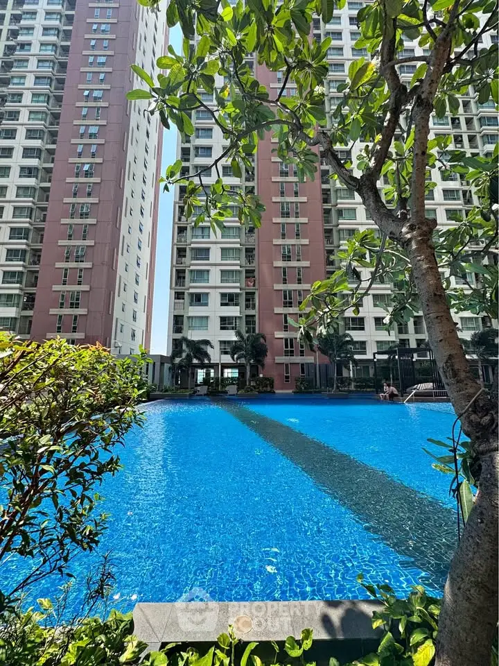 Luxurious residential complex with stunning pool and lush greenery