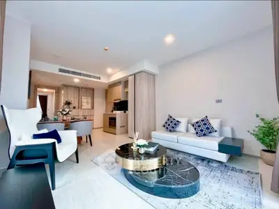 Modern living room with stylish furniture and open kitchen layout in a contemporary apartment.