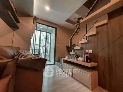Modern living room with stylish staircase and balcony access