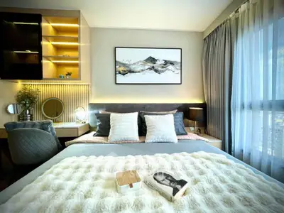 Luxurious bedroom with modern decor, large window, and elegant lighting, perfect for relaxation and comfort.
