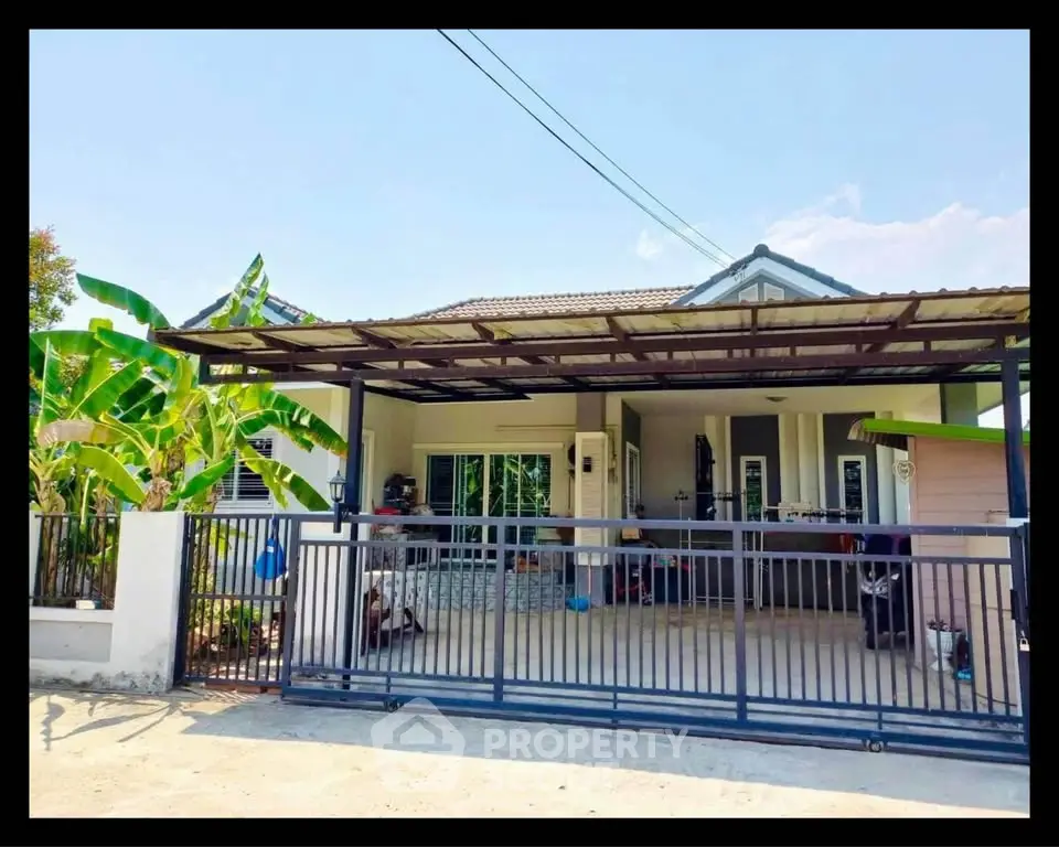 Charming single-story house with spacious front yard and covered carport, perfect for family living.