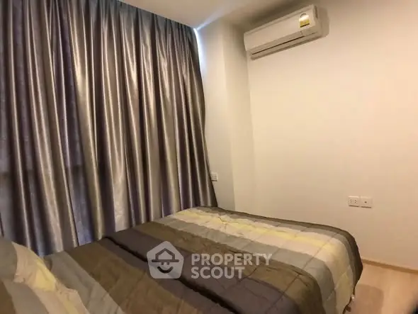 Cozy bedroom with modern air conditioning and elegant curtains