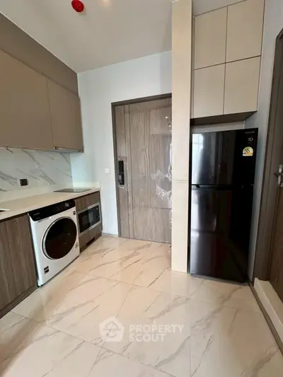 Modern kitchen with sleek appliances and marble flooring
