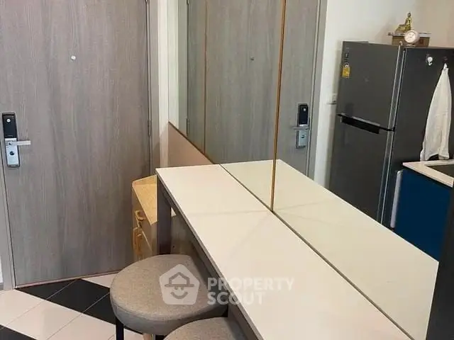 Modern apartment entryway with sleek design and mirrored wall
