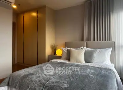 Luxurious bedroom with elegant decor and cozy ambiance, featuring plush bedding and stylish lighting.