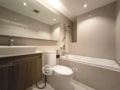 Modern bathroom with sleek design featuring bathtub and elegant fixtures.