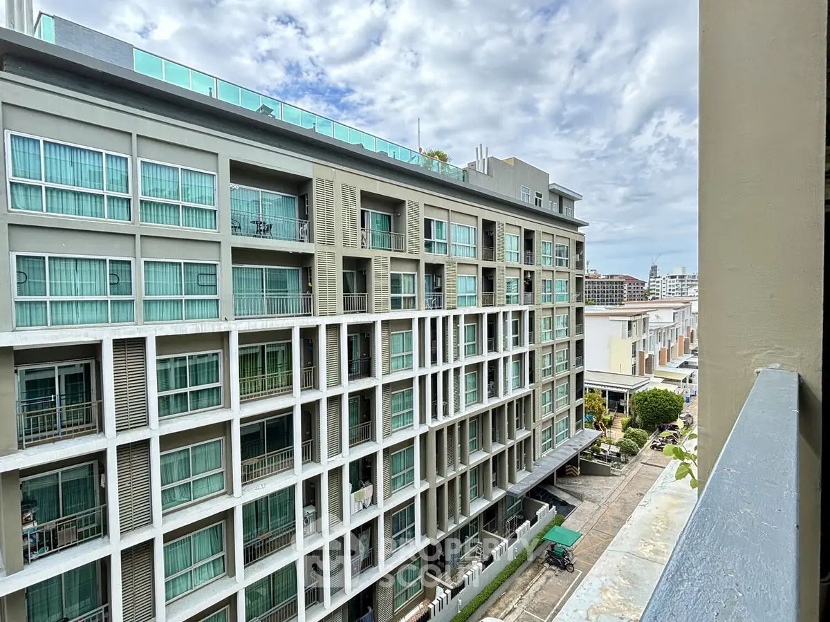 Modern apartment building with large windows and balconies, offering urban living with a view.