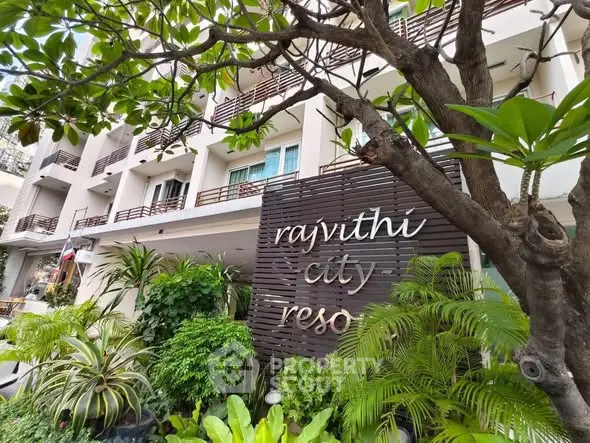 Modern city resort building with lush greenery and stylish facade