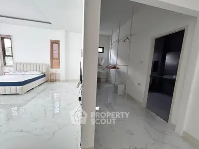 Spacious modern bedroom with marble flooring and walk-in closet