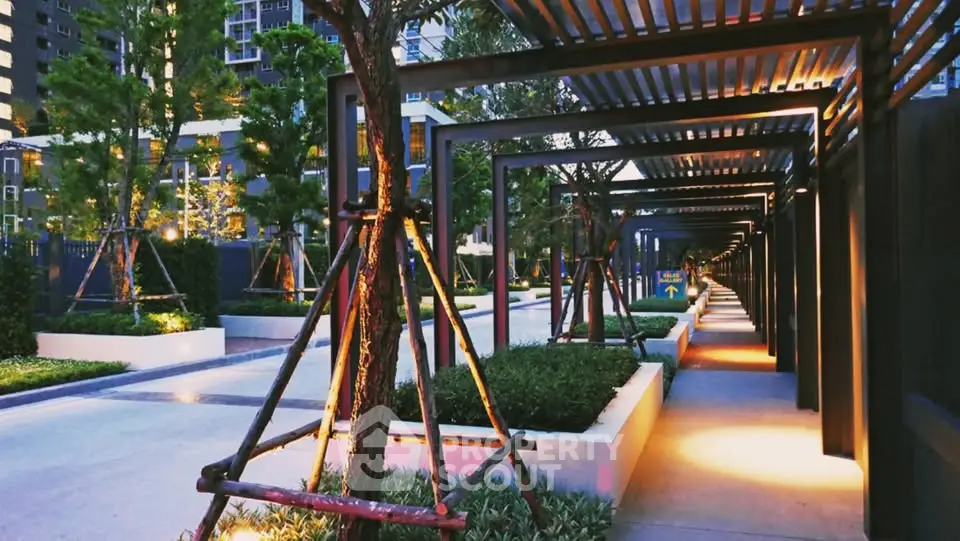 Modern urban garden with illuminated pathway and sleek architectural design.