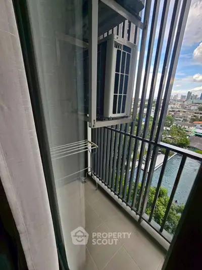 Compact balcony with city view and air conditioning unit, ideal for urban living.