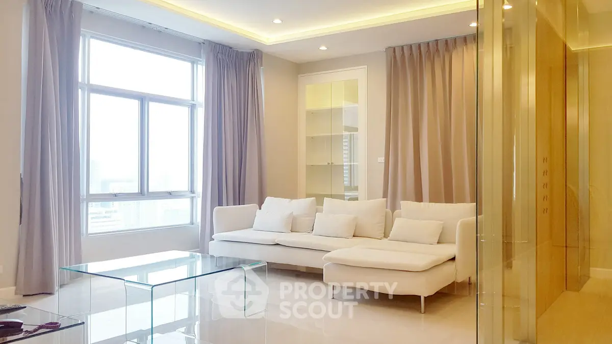 Luxurious modern living room with large windows and elegant white sofa