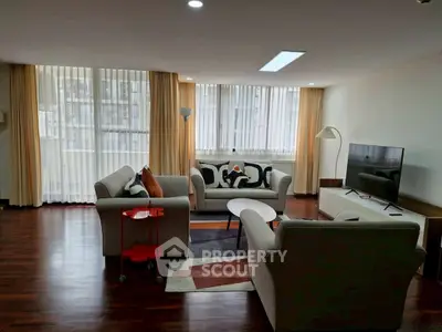 Spacious living room with modern furniture and large windows for natural light.