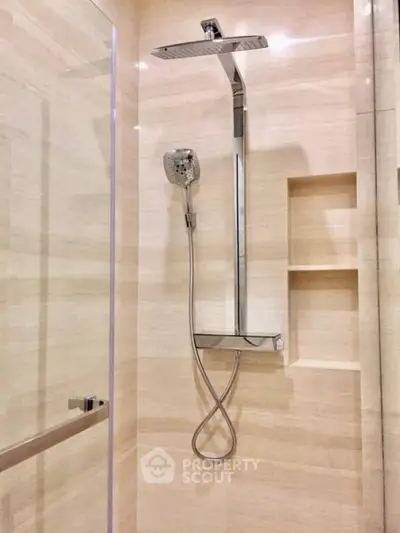 Modern bathroom with sleek shower fixtures and elegant tile design.