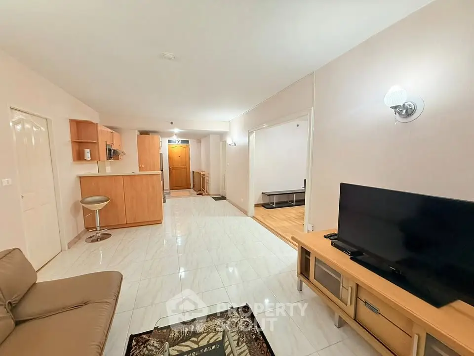 Spacious open-plan living room with modern kitchen and cozy seating area.