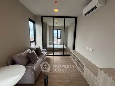 Modern living room with sleek design and large windows offering city views.