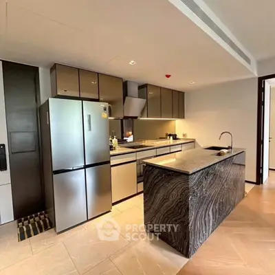 Modern kitchen with sleek cabinetry and marble island in luxury apartment
