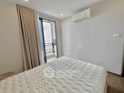 Modern bedroom with balcony access and air conditioning