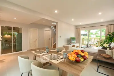 Spacious modern living room with dining area and garden view, perfect for family gatherings.