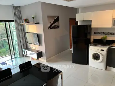 Modern open-layout kitchen and living area with balcony view