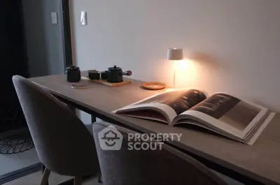 Cozy study nook with modern desk, chairs, and ambient lighting for a perfect reading corner.
