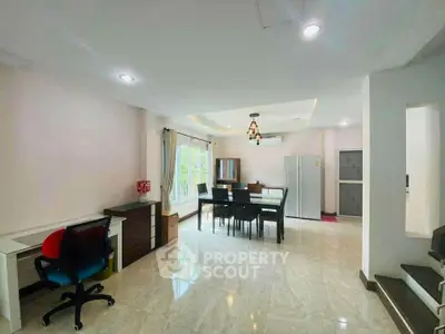 Spacious open-plan living and dining area with modern furnishings and natural light.