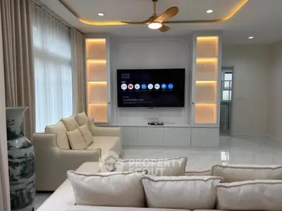 Luxurious living room with modern TV setup and elegant lighting, perfect for relaxation and entertainment.