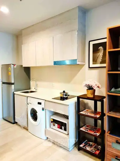 Modern kitchen with washing machine and fridge in compact layout
