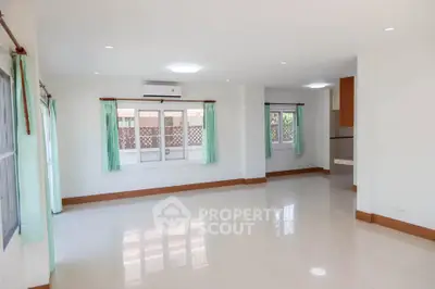 Spacious empty living room with large windows and natural light