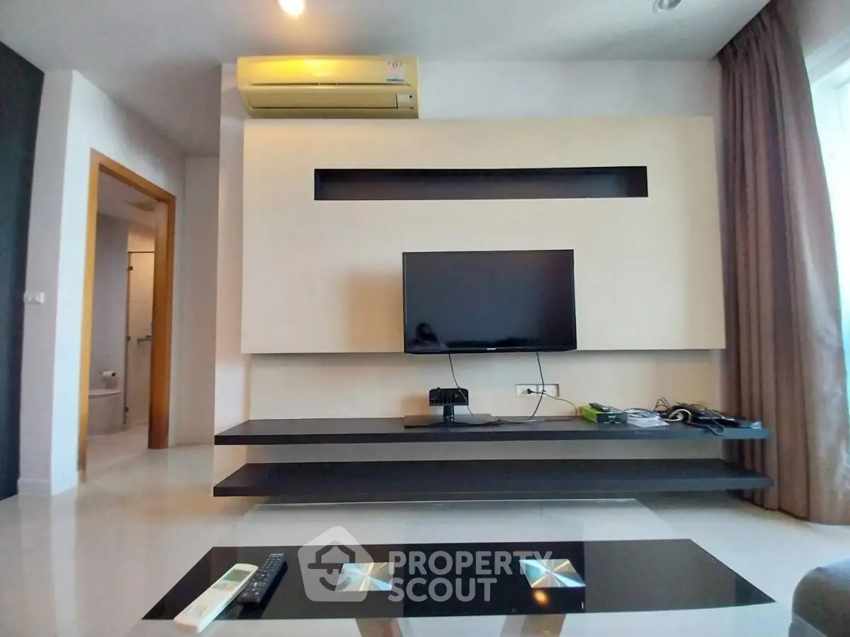 Modern living room with sleek TV setup and air conditioning