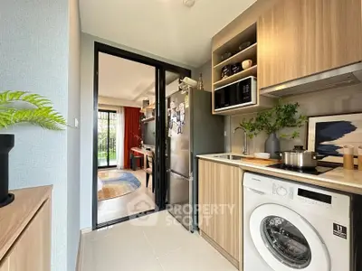 Modern kitchen with washing machine and open layout to living room