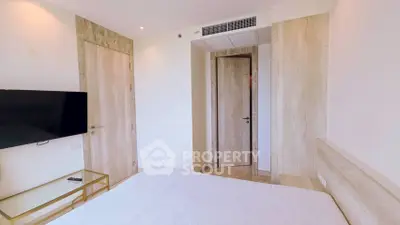 Modern bedroom with minimalist design and wall-mounted TV