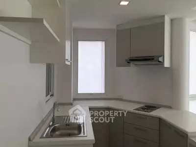 Modern kitchen with sleek cabinetry and built-in stove in a minimalist design.