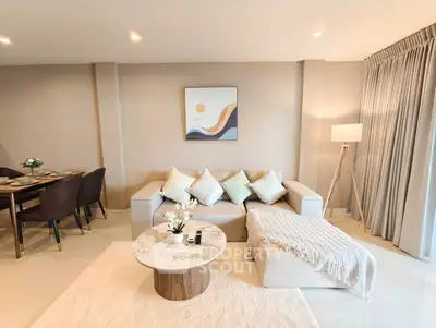 Elegant living room with modern decor and cozy seating area, perfect for relaxation and entertaining.