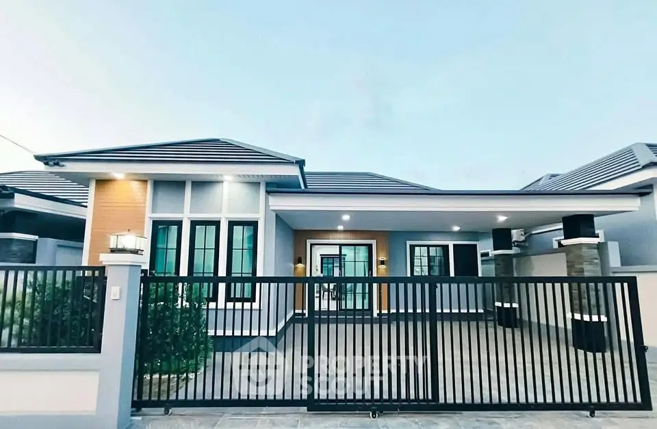 Modern single-story house with sleek design and gated driveway