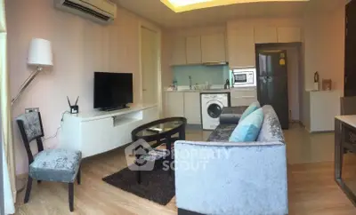 Modern living room with stylish furniture and integrated kitchen appliances in a cozy apartment.