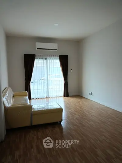Spacious living room with modern air conditioning and natural light
