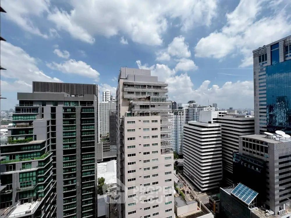 Stunning cityscape view with modern high-rise buildings under a vibrant blue sky.