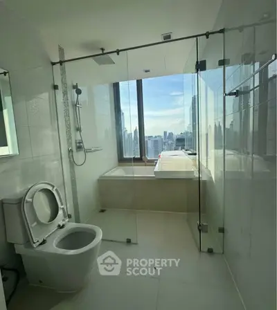 Luxurious bathroom with city view, featuring glass shower and modern fixtures.