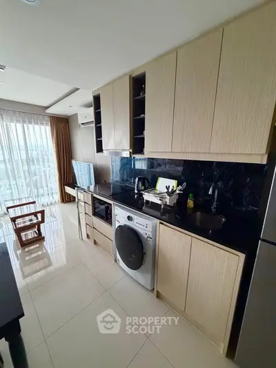 Modern kitchen with sleek cabinetry and built-in appliances in a high-rise apartment.