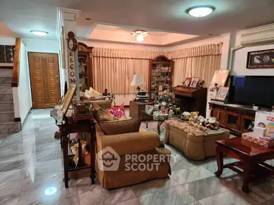 Spacious living room with elegant decor and cozy seating area, perfect for family gatherings.