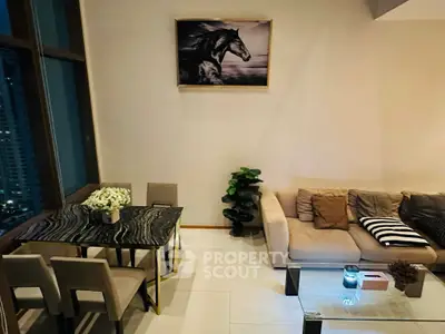 Elegant living room with modern decor and city view, featuring a stylish dining area and cozy seating.