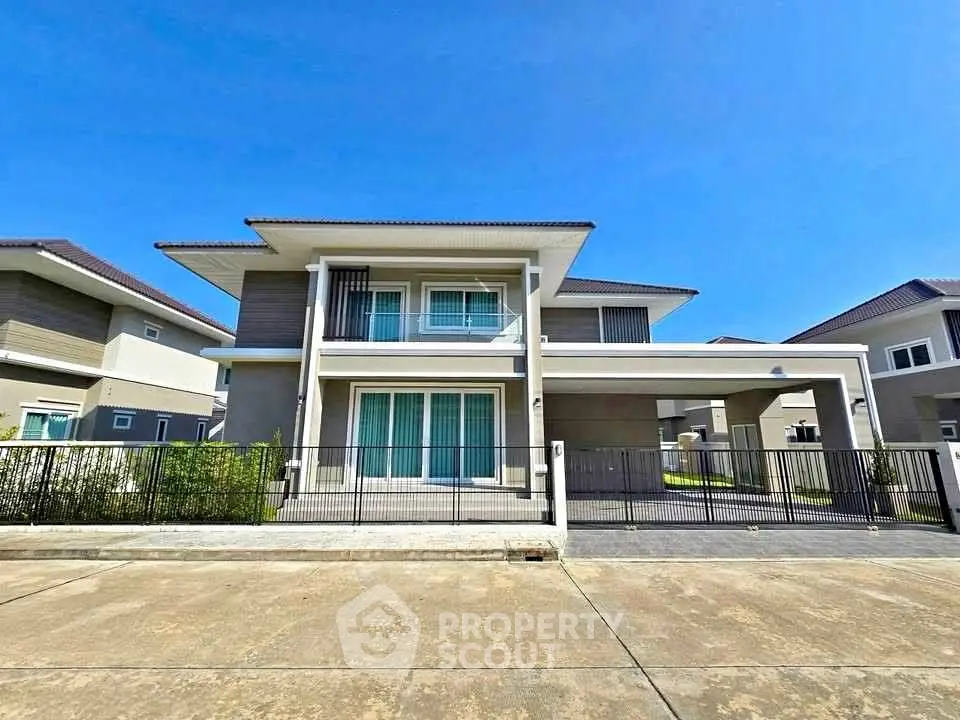 Modern two-story house with spacious driveway and sleek design