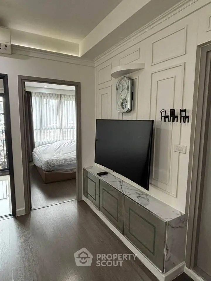 Modern apartment interior with stylish TV setup and cozy bedroom view