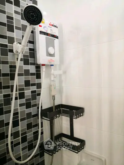 Modern bathroom with sleek showerhead and stylish black tile accents