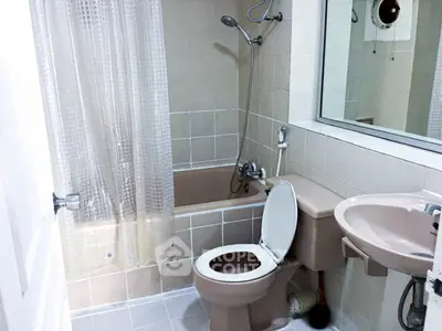 Cozy bathroom with bathtub and modern fixtures in a stylish apartment.